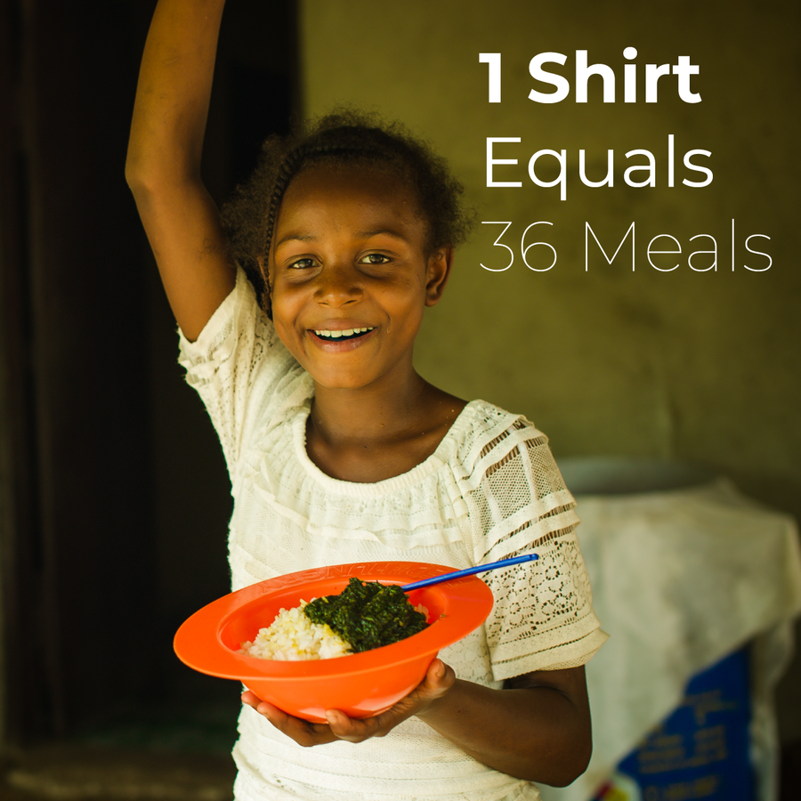 A young Liberian girl is smiling and holding a bowl of rice. The top right corner of the photo says 1 Shirt equals 36 Meals